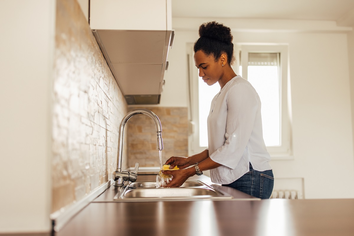 woman doing dishes - what does a water softener do