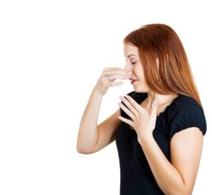 woman holding her nose - rotten egg smell in water
