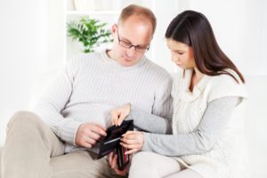 a couple looking at their wallet - water softener cost